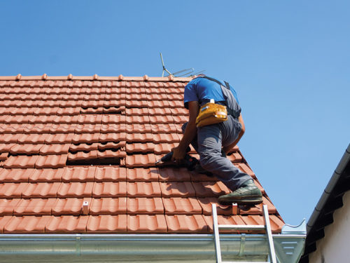 Roofer Repairing The Damaged Roof Atlanta Ga 500x375 1